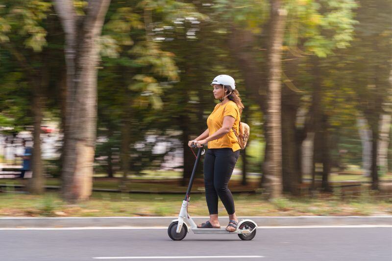 woman riding electric scooter