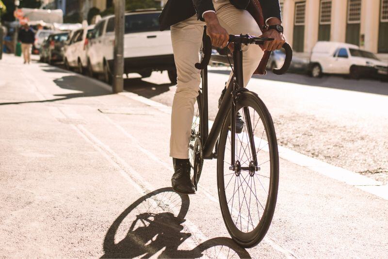 man in suit riding a bicycle