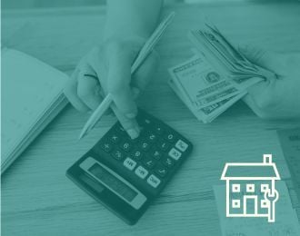 Image of a person's hands holding money and using a calculator