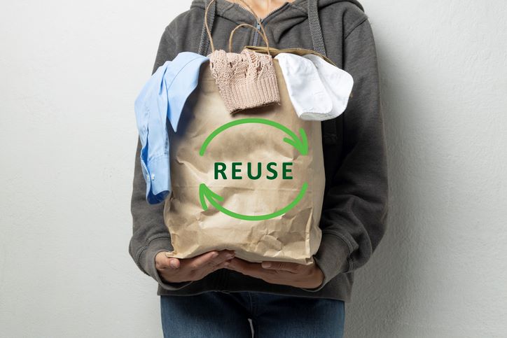 woman holding a bag of clothes to donate